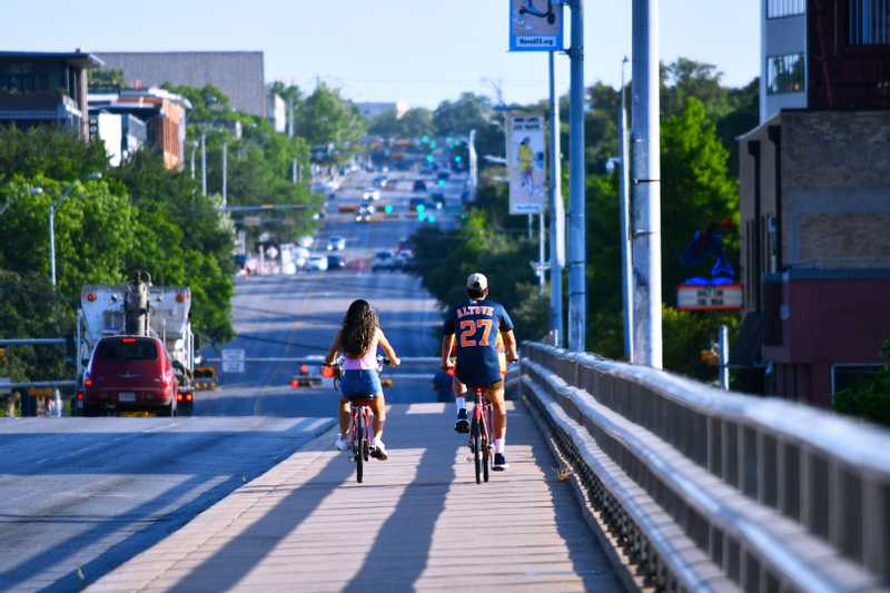 couple biking on bridge