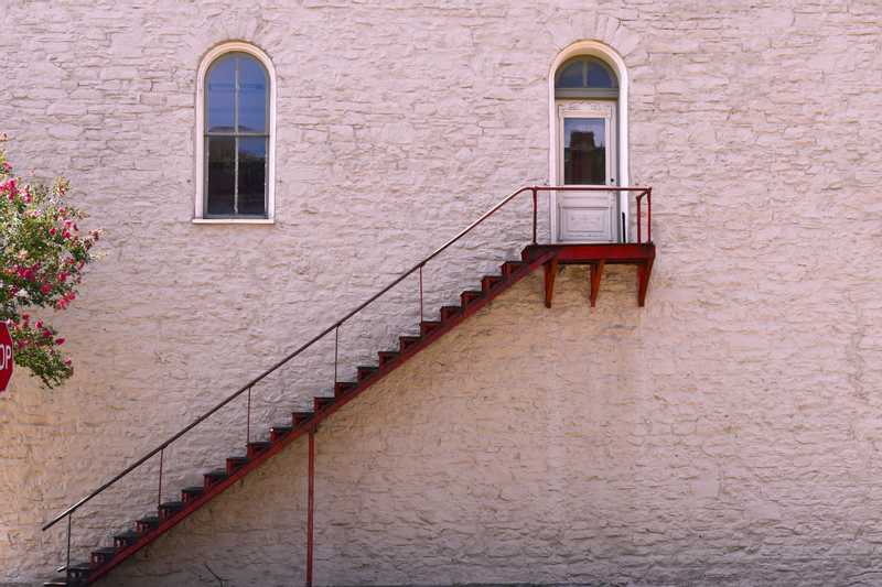 Door on side of building with staircase down