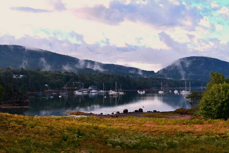 Boats in the bay with a cloudy, foggy backdrop